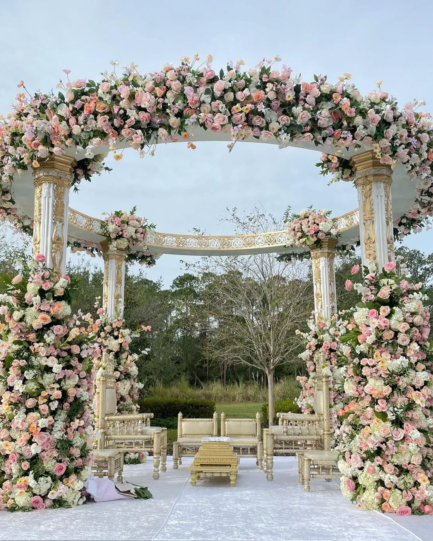 Blush Mandap Outdoor mandap with cascading blush rose pillars and gold columns